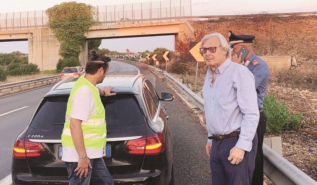 Vittorio Sgarbi alle prese con la foratura di uno pneumatico