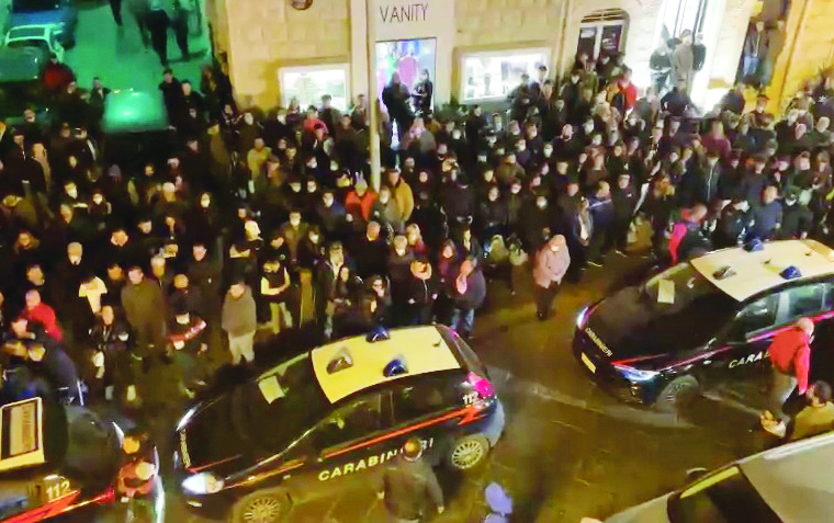 La folla davanti alla caserma dei carabinieri di Corato dopo i quattro arresti e il sindaco De Benedittis