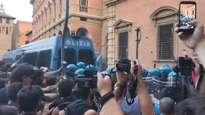 Morto ammanettato a Bologna, coro “assassini” e tensioni tra agenti e corteo: polizia usa idranti e lacrimogeni